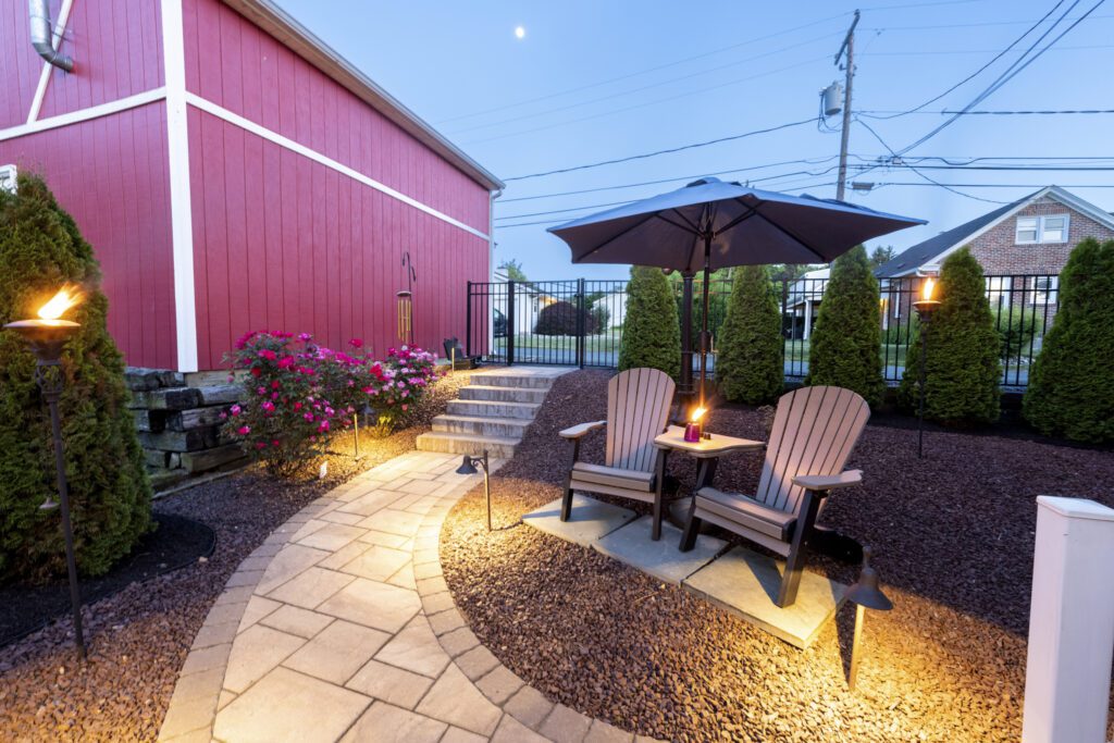 Two chairs along a Techo-blok paver walkway with outdoor lighting in Macungie