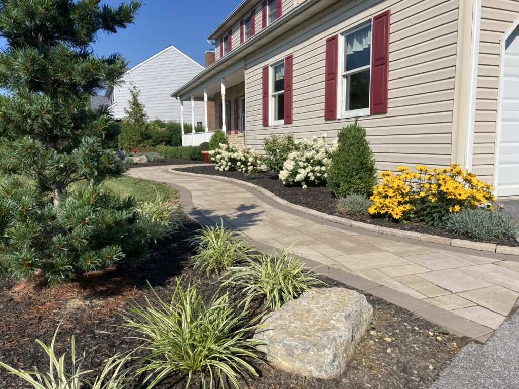 Techo-blok paver walkway with edgestone and landscaped mulch beds with flowers and shrubs in Schnecksville