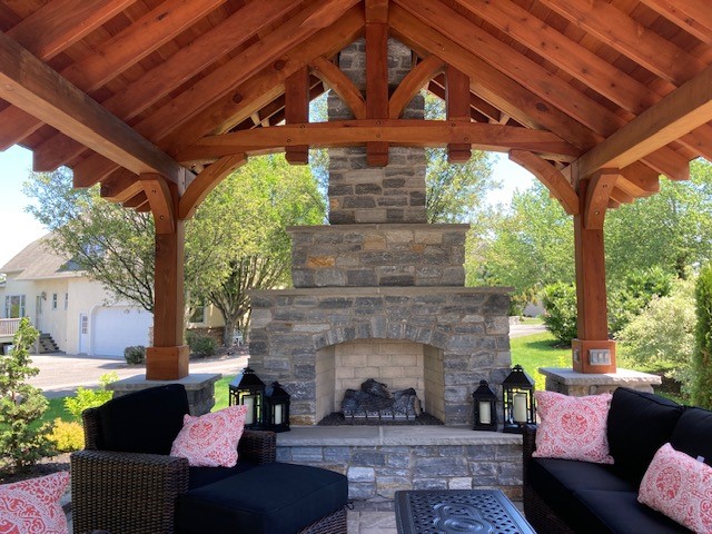 Cedar pavilion with stone fireplace and outdoor furniture