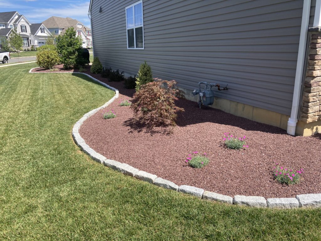 Red decorative stone landscape bed with edge stone border in Bethlehem
