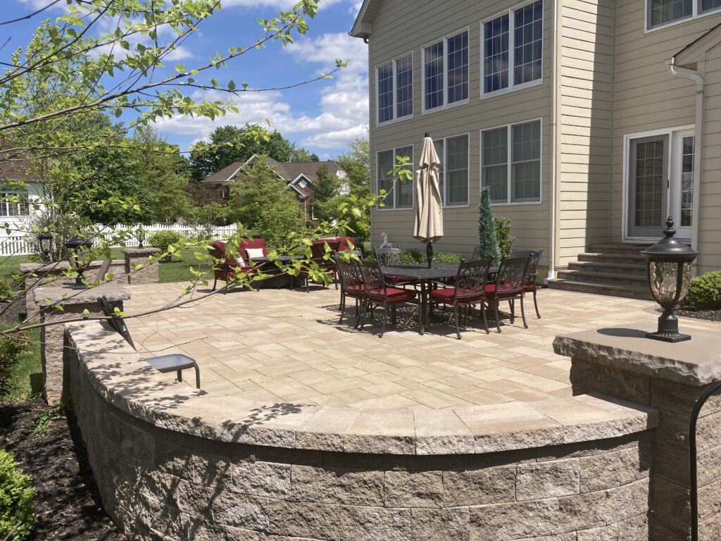 Landscaped paver patio with outdoor lighting
