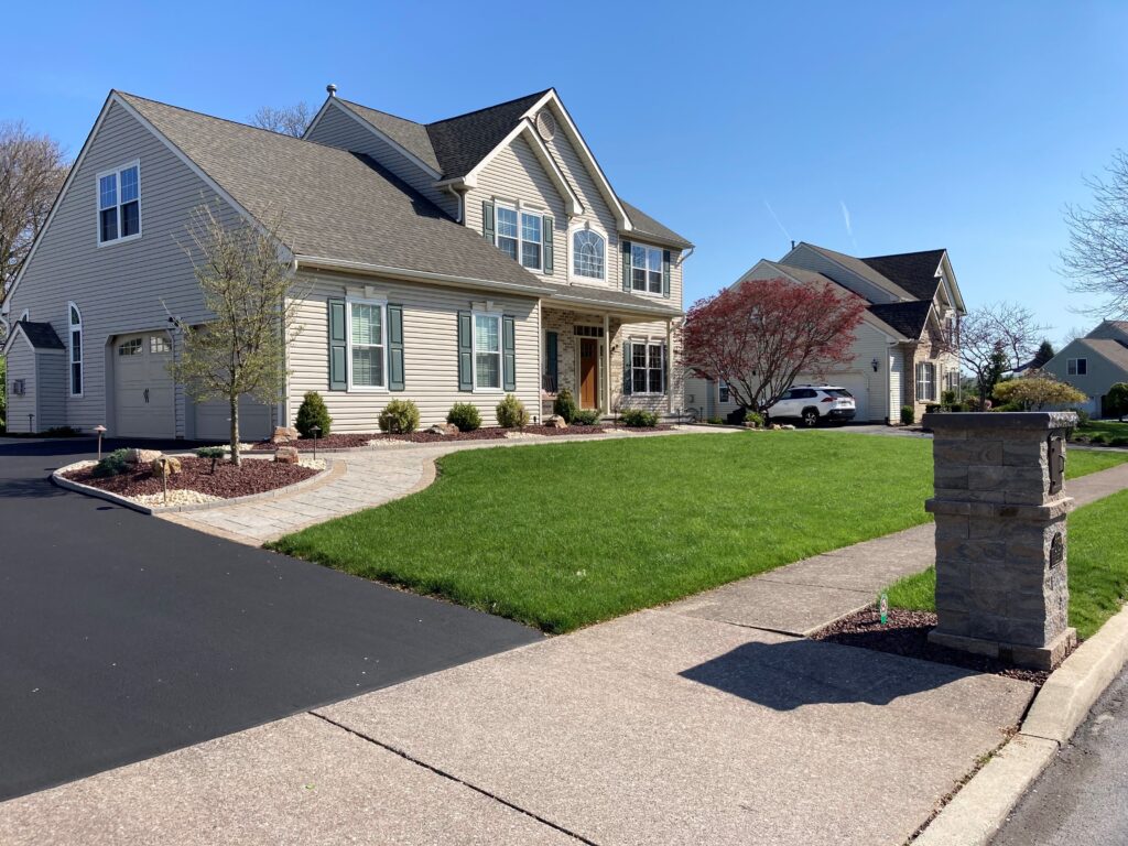 Healthy green lawn in front of hardscaped home