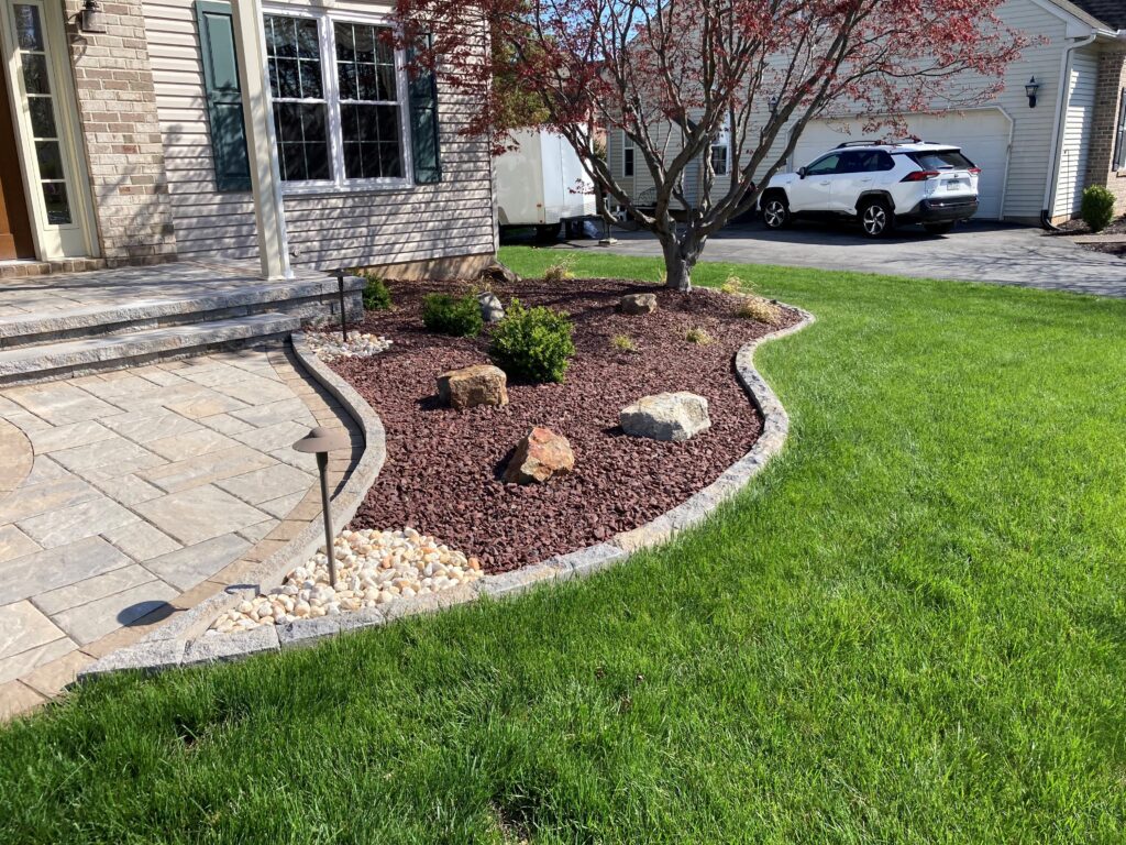 Landscaped stone bed with lighting and paver walkway