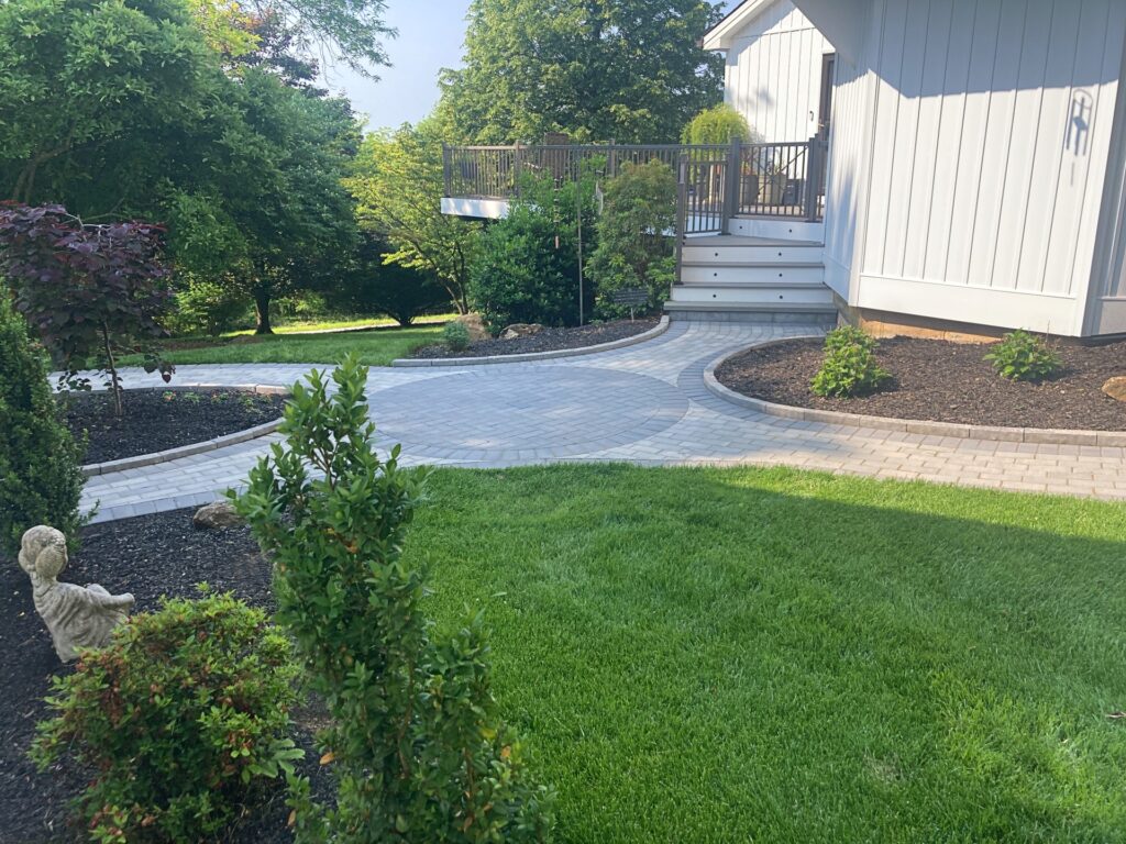 Green lawn with unique paver walkway
