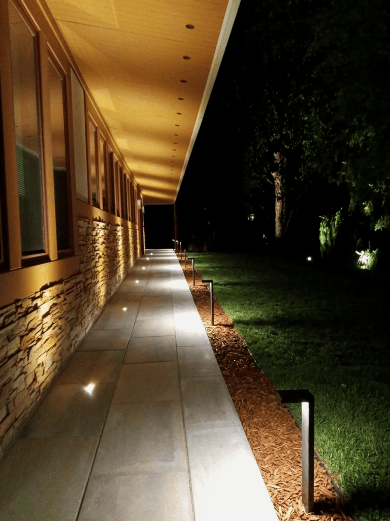A contemporary paver walkway with outdoor lighting