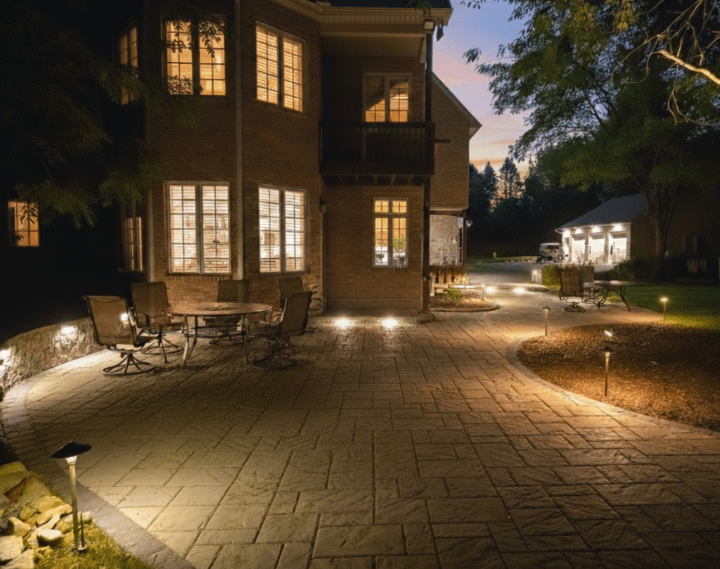 A free-flowing paver patio with outdoor lighting